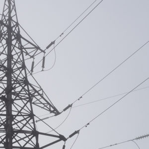 Electric high voltage power towers at morning mist